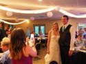 Jessica takes a picture of the married couple