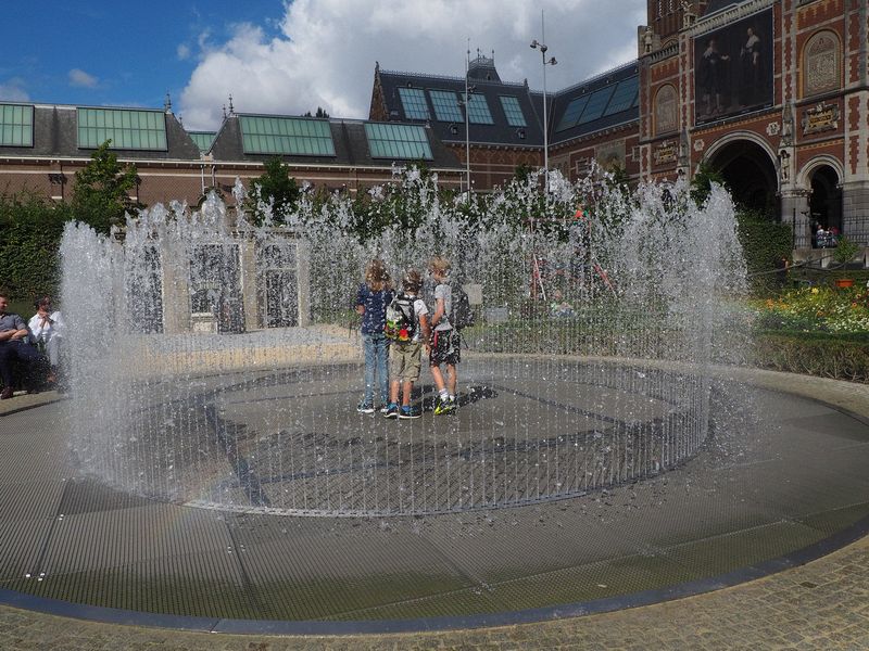 Boys standing within a fountain