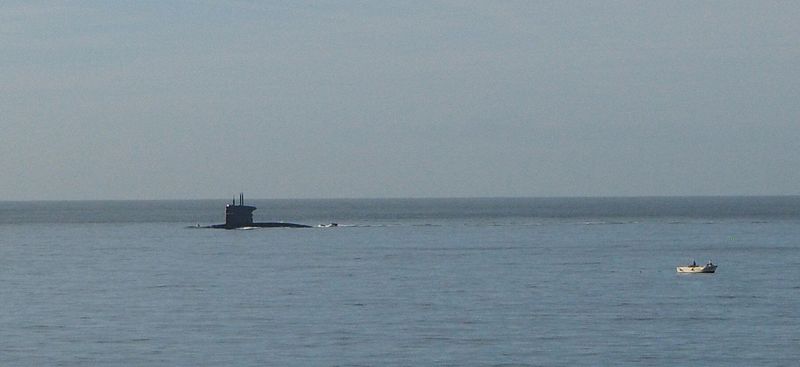 We see a submarine entering Lisbon harbor