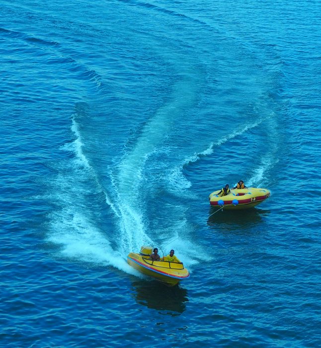 Speedboat towing an inflatable raft