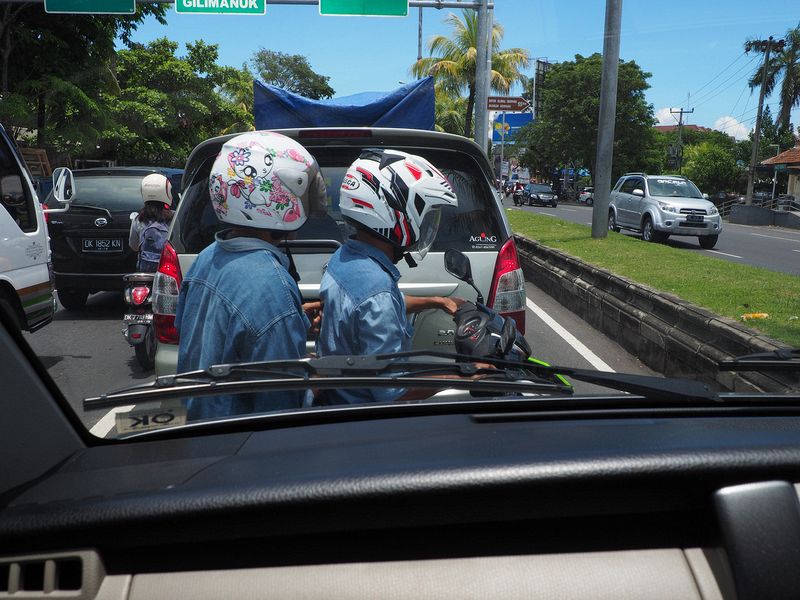 Motorbikes squeeze between the cars