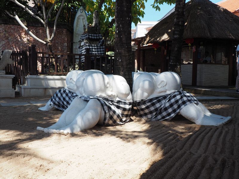 Statues of children hiding their faces