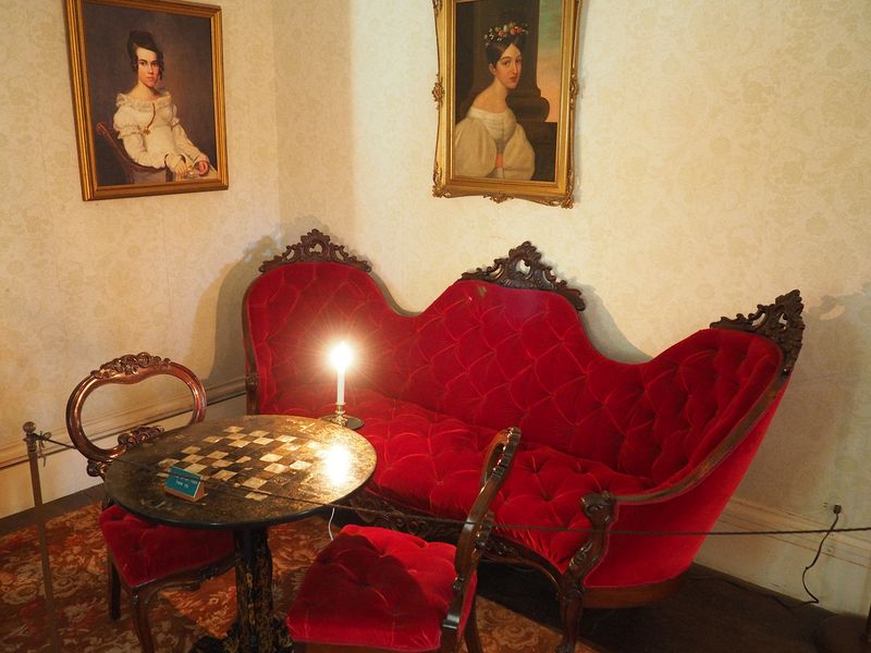 Red sofa and family portraits