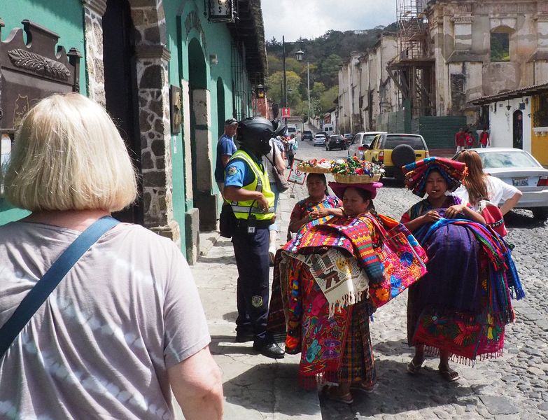 These women want to sell colorful blankets to Linda