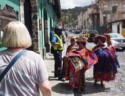 These women want to sell colorful blankets to Linda