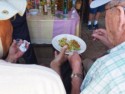 A shot of mezcal followed by a slice of lime with spicy seasonings