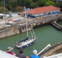 A sailboat goes through the locks next to us