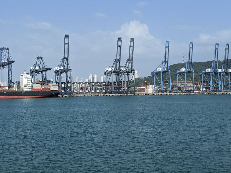 Cargo cranes with Panama City skyscrapers in the distance