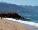 Launching a fishing boat from the beach