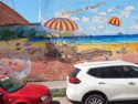 Skeltonized tourists on a mural