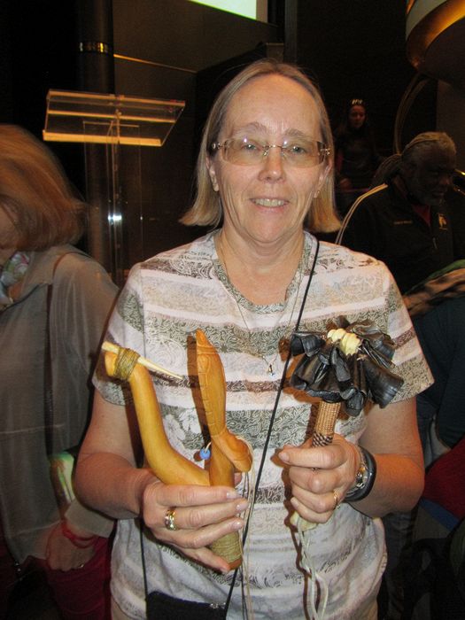 June holds a Tlingit fish hook and artwork
