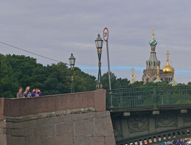 People wave from a bridge as we head towards the Church of the Spilled Blood