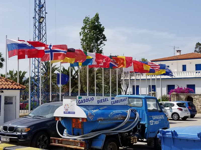 Flags from lots of countries next to a refueling truck