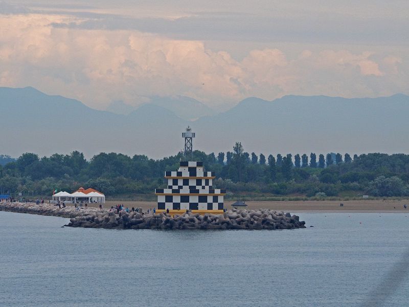 Punta Sabbioni lighthouse with Dolomite Mountains in the background