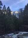 A rushing stream and a high waterfall on the cliff