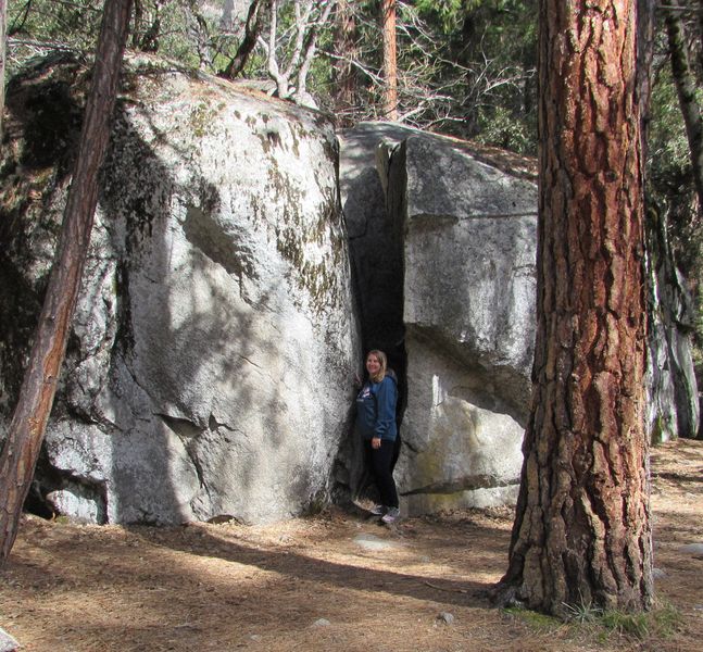 Jen next to a big crack in a huge rock