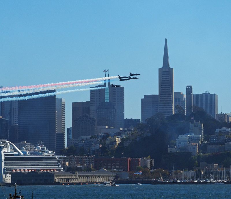 The Patriots fly by the city skyline