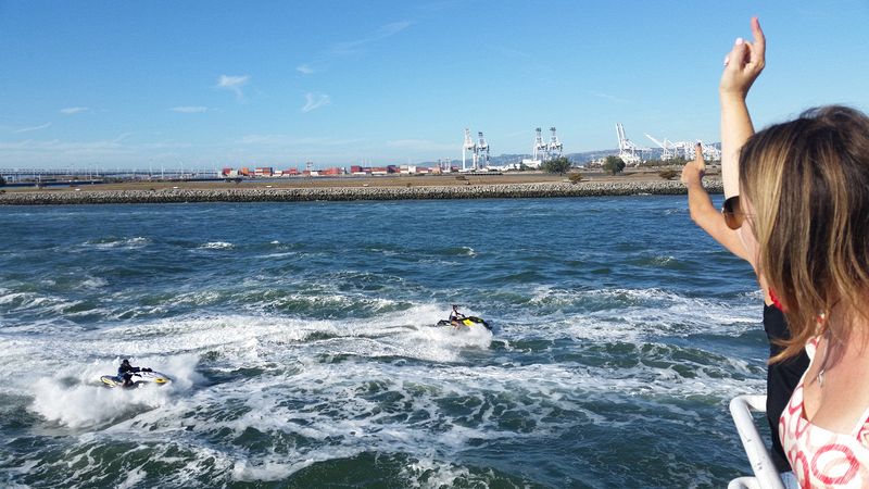 Waving to jet skis in the estuary