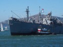 A tugboat helps the Jeremiah O'Brien museum ship from turning in the wind