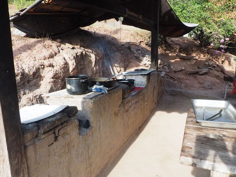 Everything is cooked over wood fires in this crude outdoor kitchen