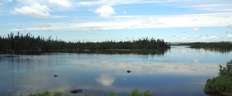The sky reflecting off a pond