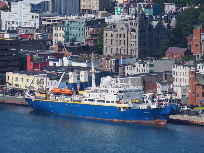 Blue ship docked downtown