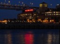 Building lights reflect red on the water