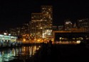 Lights from buildings reflect off the water