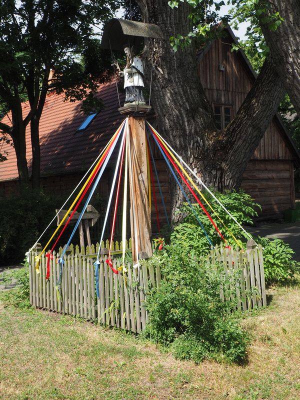Shrine with colorful streamers tied to the fence