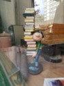 Figurine in a window carrying books