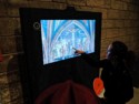 Most of the colorful wall paintings are gone, so we look at a re-creation on a TV