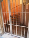 Spiral stone staircase behind bars